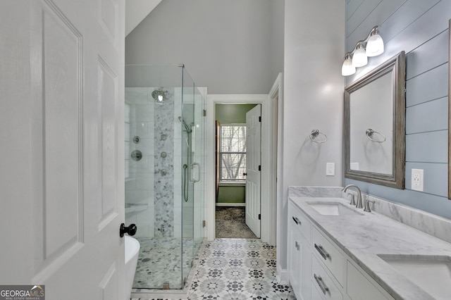 bathroom featuring shower with separate bathtub, vaulted ceiling, and vanity