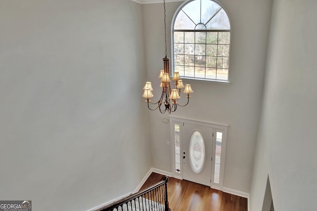 foyer entrance featuring hardwood / wood-style flooring and an inviting chandelier