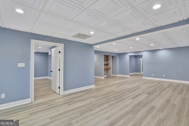 basement with light hardwood / wood-style flooring