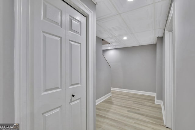 basement with light hardwood / wood-style flooring