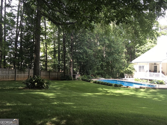 view of yard with a fenced in pool