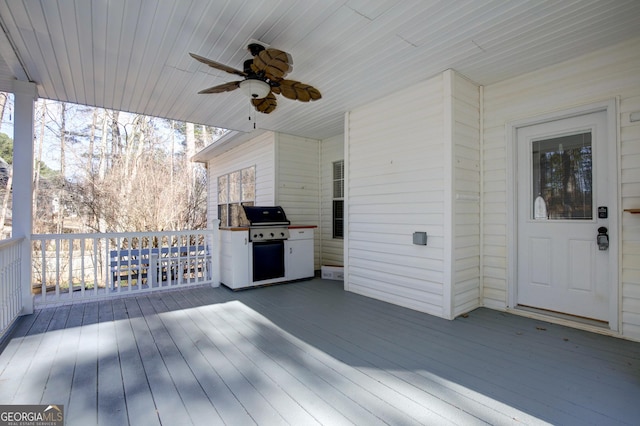 deck with a grill and ceiling fan