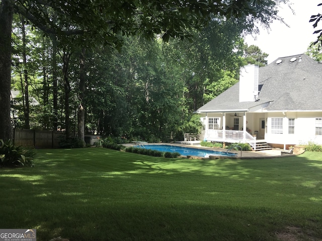 view of yard with a swimming pool side deck