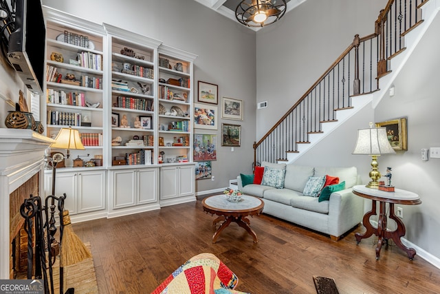 living room with a high ceiling and wood-type flooring