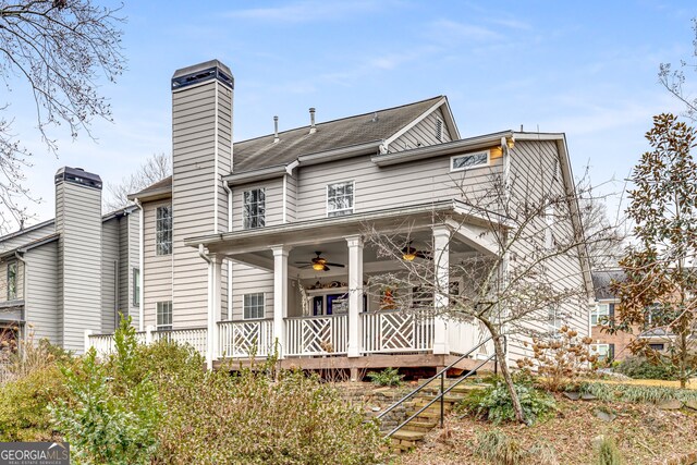 rear view of property with ceiling fan and a porch