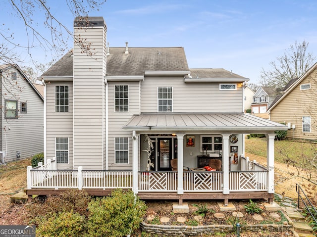 rear view of house featuring covered porch