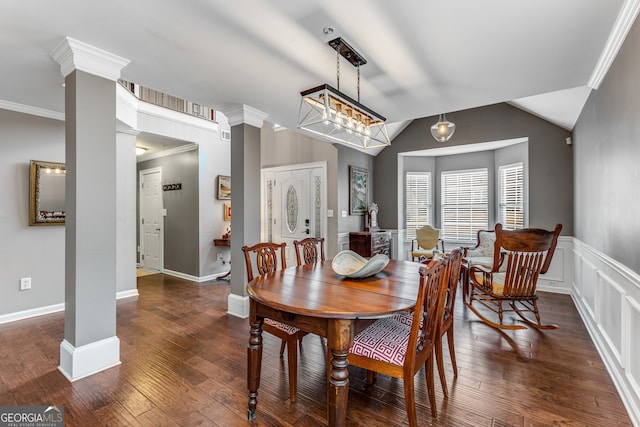 dining room featuring ornamental molding, decorative columns, dark hardwood / wood-style floors, and vaulted ceiling