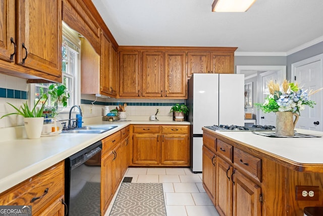 kitchen with sink, crown molding, dishwasher, tasteful backsplash, and stainless steel gas stovetop