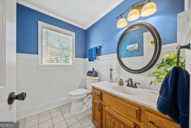 bathroom with toilet, a textured ceiling, ornamental molding, vanity, and tile patterned flooring