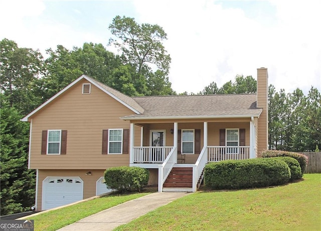 view of front of house with a garage, a front yard, and covered porch