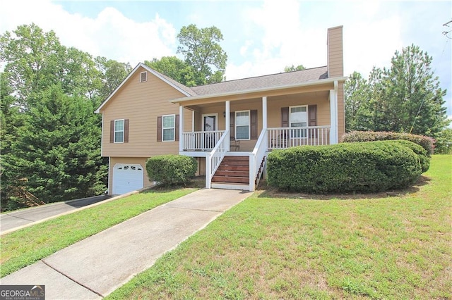 view of front facade with a garage, a front lawn, and covered porch