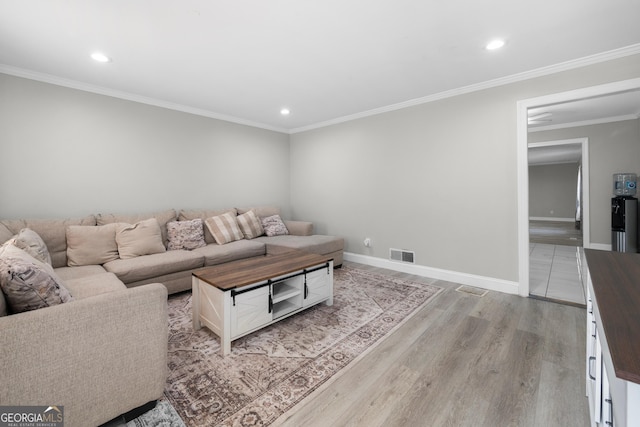 living room featuring ornamental molding and light wood-type flooring