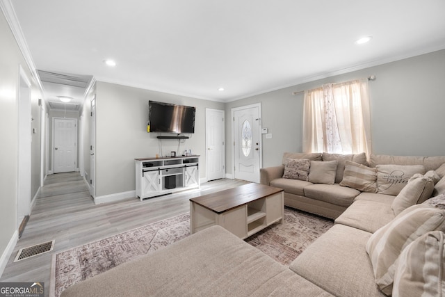 living room with crown molding and light hardwood / wood-style flooring