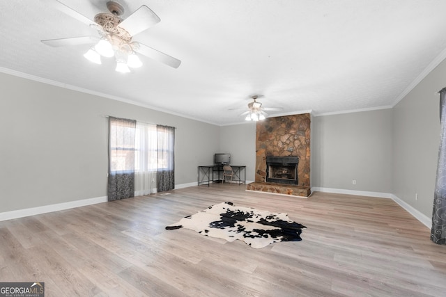 unfurnished living room featuring crown molding, a fireplace, and light wood-type flooring