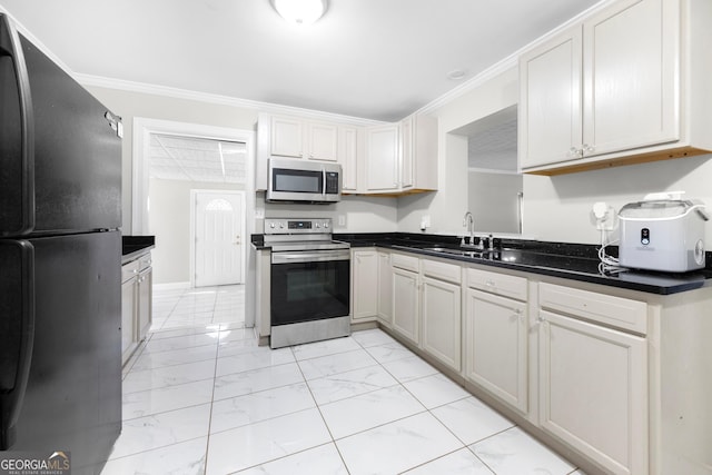 kitchen with crown molding, white cabinetry, stainless steel appliances, and sink