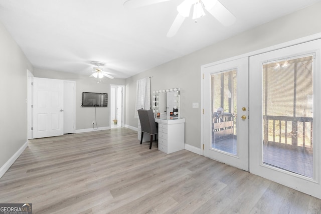 unfurnished office featuring light hardwood / wood-style flooring, a wealth of natural light, ceiling fan, and french doors