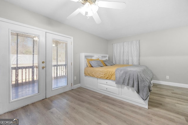 bedroom with access to exterior, light hardwood / wood-style floors, french doors, and ceiling fan