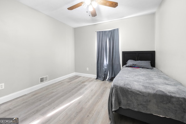 bedroom with light hardwood / wood-style flooring and ceiling fan