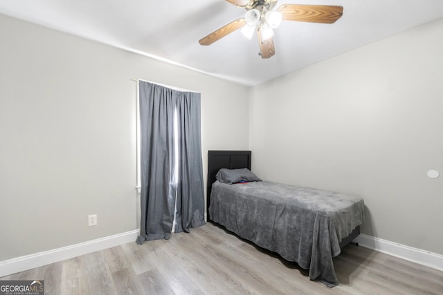 bedroom featuring light hardwood / wood-style flooring and ceiling fan