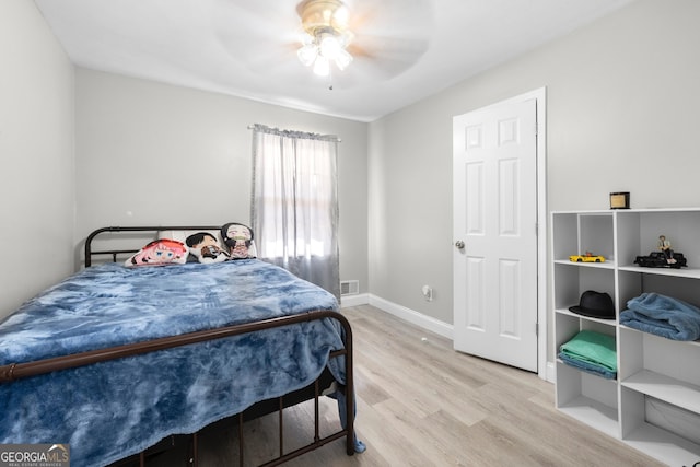 bedroom with light hardwood / wood-style floors and ceiling fan