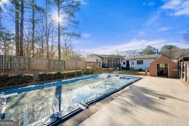 view of swimming pool featuring a sunroom and a storage shed