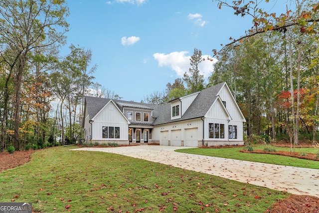 modern farmhouse style home featuring a garage and a front lawn