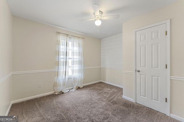 empty room with ceiling fan and carpet