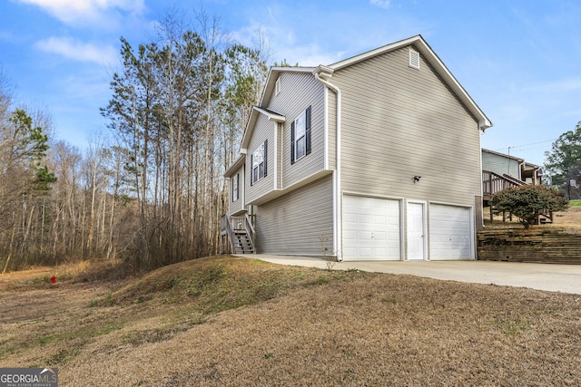 view of side of property with a garage and a yard