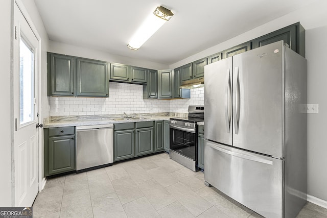 kitchen with tasteful backsplash, sink, and stainless steel appliances