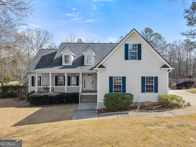 cape cod-style house with a front yard and a porch