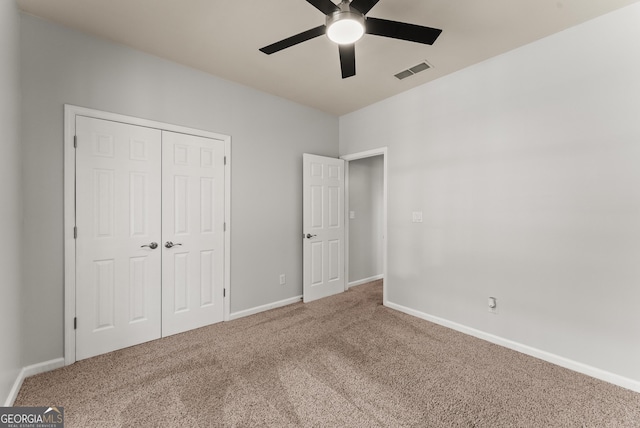 unfurnished bedroom featuring a closet, ceiling fan, and carpet