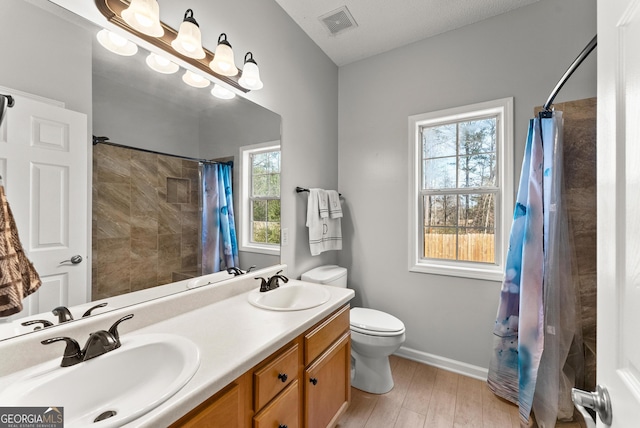 bathroom with a shower with curtain, vanity, toilet, and hardwood / wood-style floors