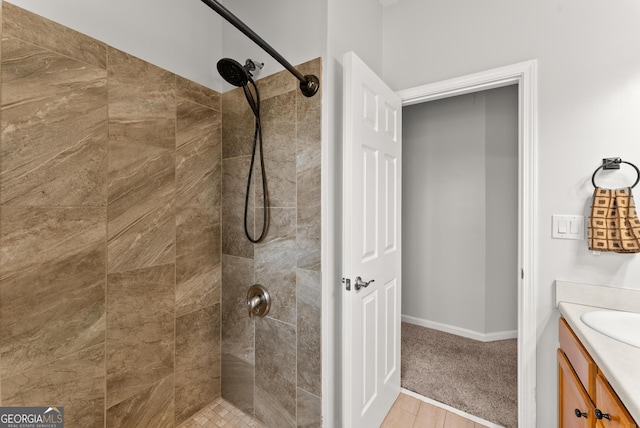 bathroom featuring tiled shower, vanity, and hardwood / wood-style floors