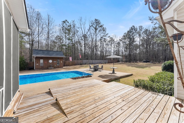 view of swimming pool with a yard, an outbuilding, and a patio area