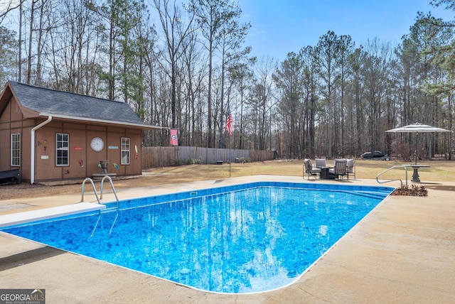 view of swimming pool with an outbuilding and a patio area