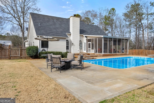 exterior space with a diving board, a lawn, a sunroom, and a patio