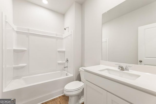 full bathroom with vanity, hardwood / wood-style floors,  shower combination, and toilet