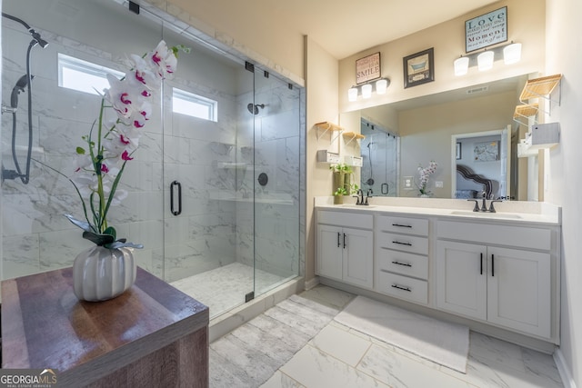 bathroom with vanity and a shower with door