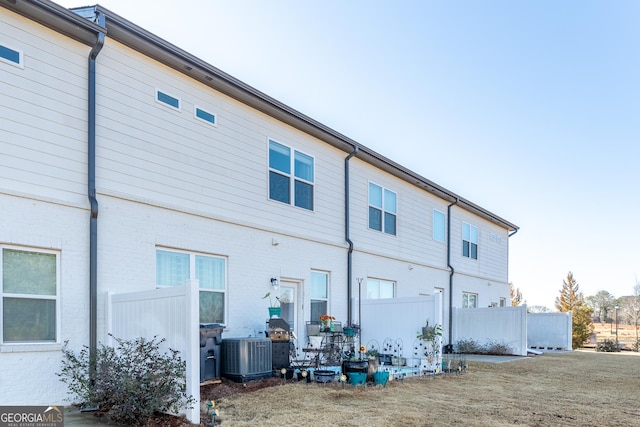 back of house featuring cooling unit