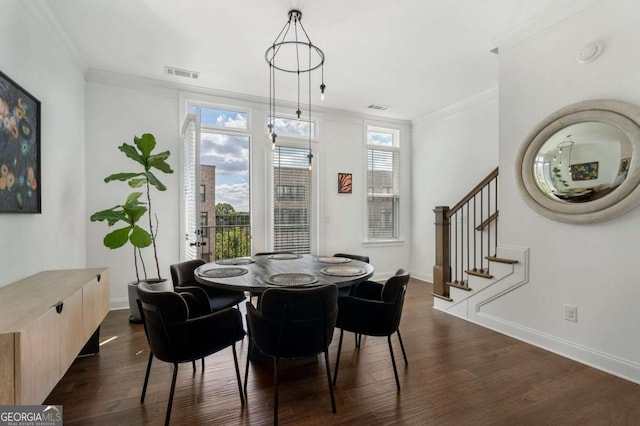 dining area with crown molding and dark wood-type flooring