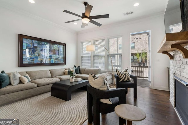 living room with crown molding, dark hardwood / wood-style floors, and ceiling fan