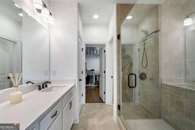 bathroom with vanity, tile patterned flooring, and a shower with door