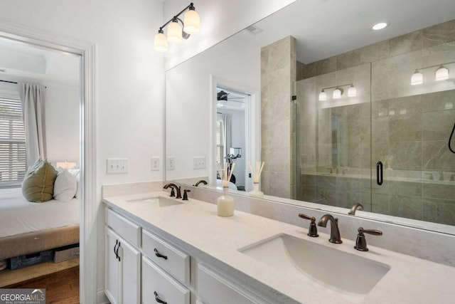 bathroom with an enclosed shower and vanity