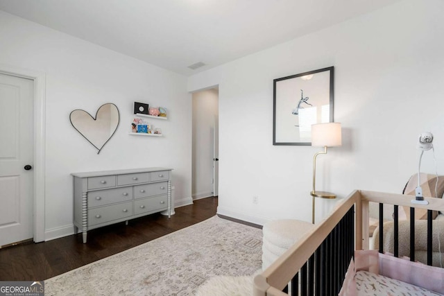 bedroom with dark wood-type flooring