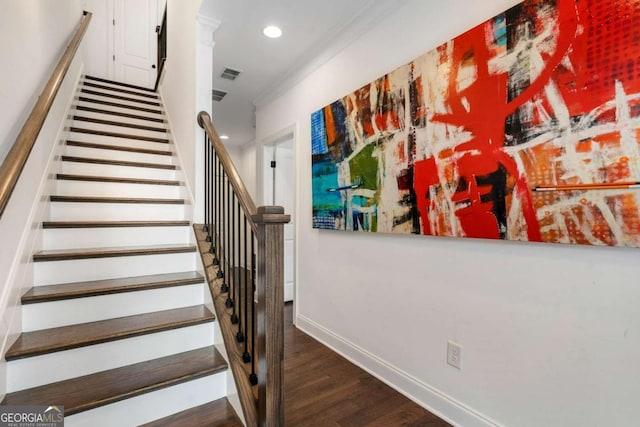 stairs featuring ornamental molding and hardwood / wood-style floors