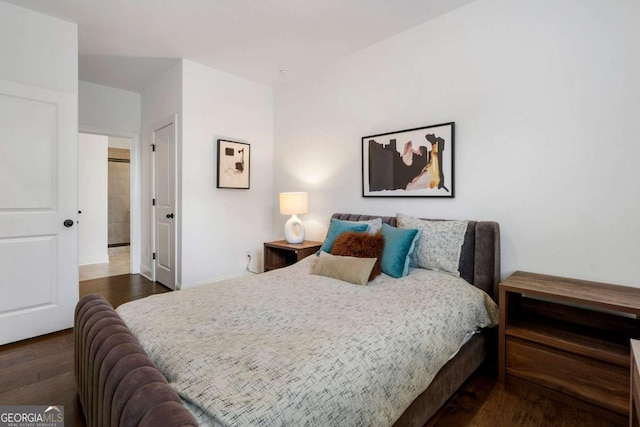 bedroom with dark hardwood / wood-style floors