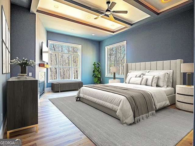 bedroom featuring beamed ceiling, multiple windows, and light wood-type flooring