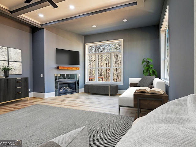 living area featuring recessed lighting, baseboards, a tiled fireplace, and wood finished floors