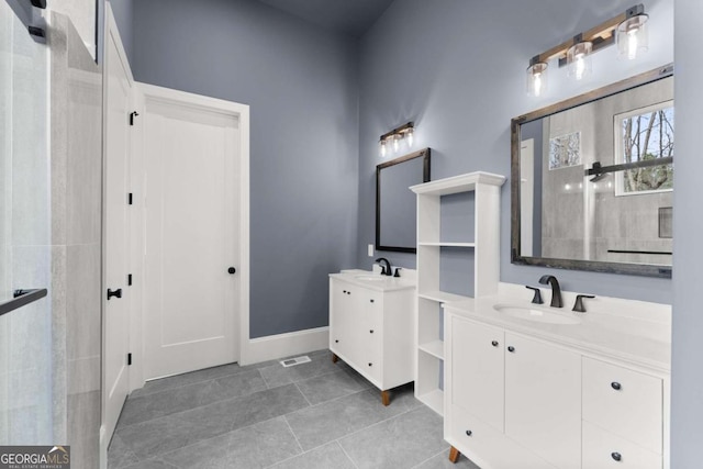 full bathroom featuring two vanities, a sink, baseboards, and tile patterned floors