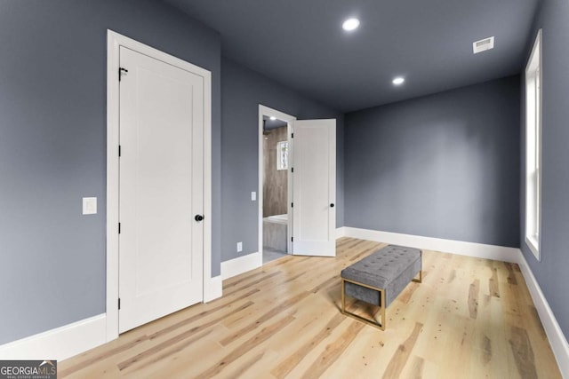 interior space featuring light wood-style floors, recessed lighting, visible vents, and baseboards